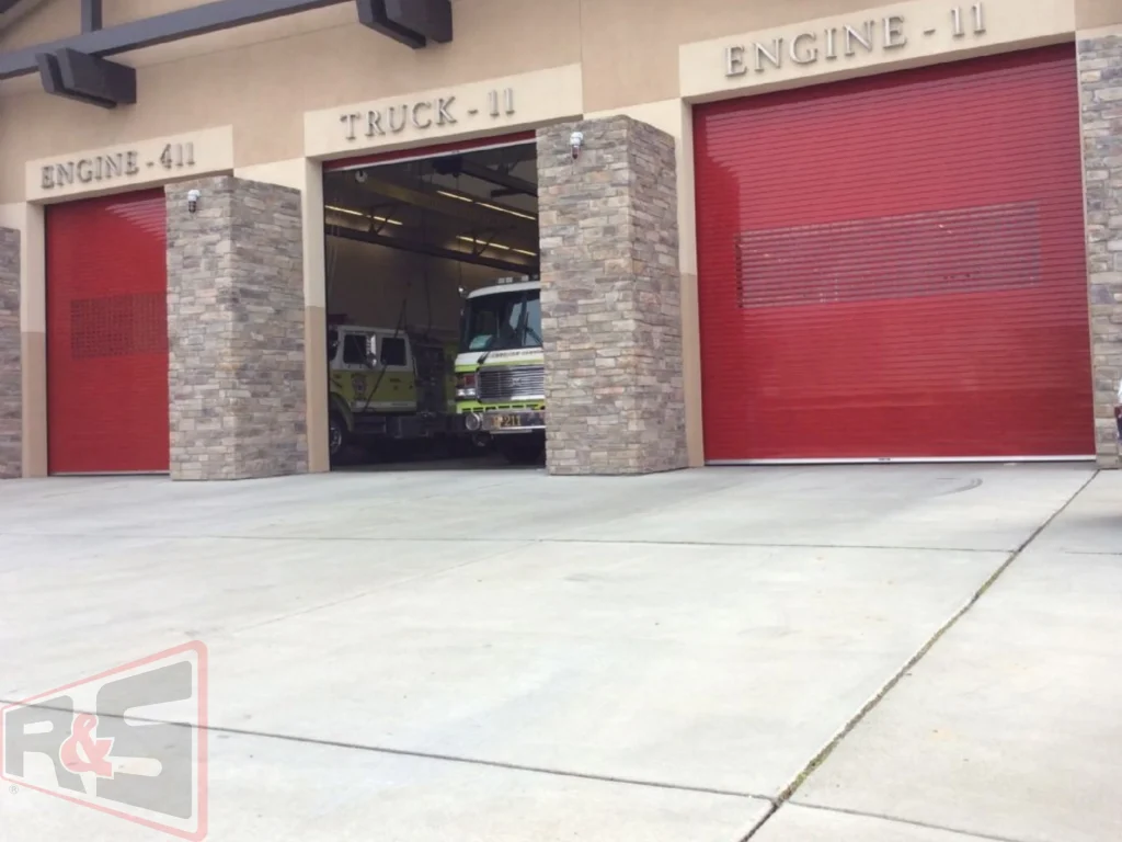 Bright red heavy-duty roll-up fire station bay doors representing Commercial Garage Doors in Vallejo, CA.