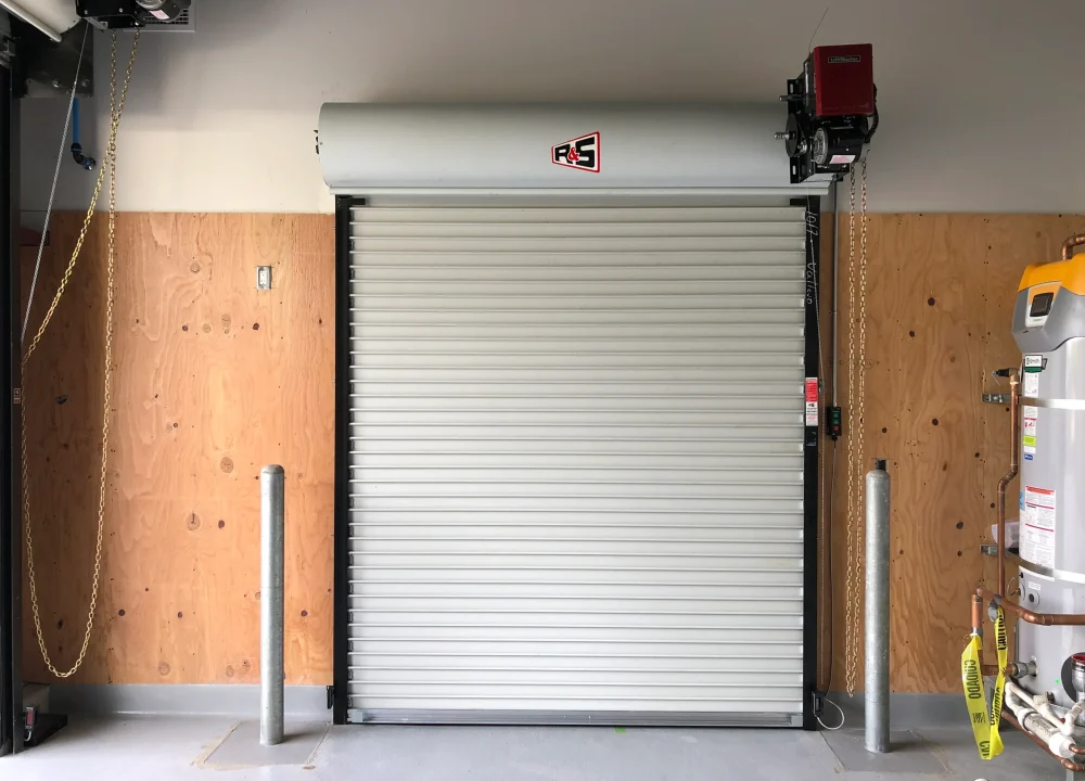 An interior view of a motorized rolling steel door showcasing Why Your Business Needs a Commercial Door Operator.